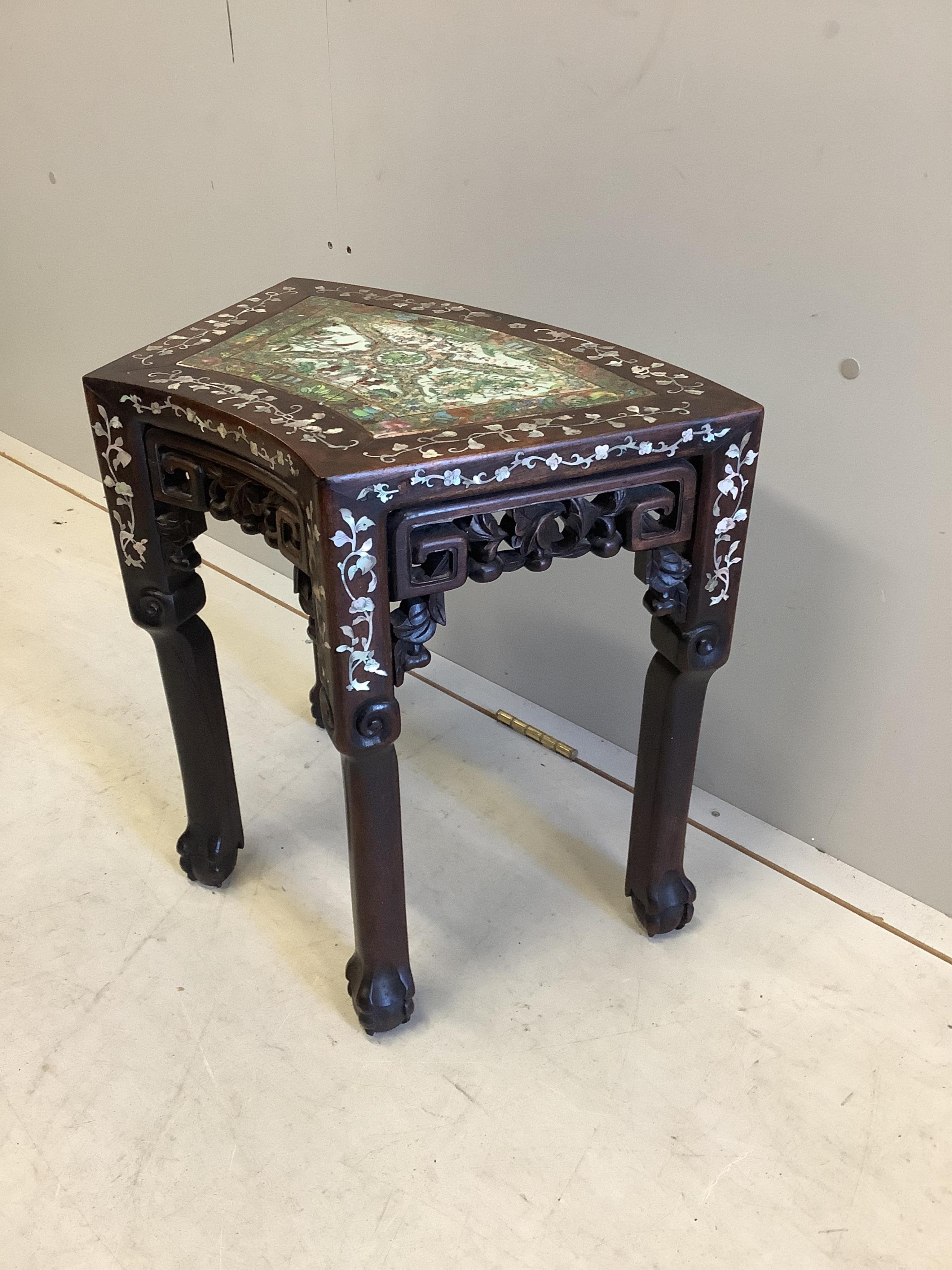 A Chinese mother of pearl inlaid hongmu vase stand, with famille rose porcelain inset top, (cracked), width 49cm, depth 31cm, height 47cm